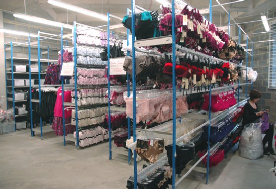 Warehouse shelves stocked with lingerie and women&rsquo;s fashion inventory organized for order fulfillment and ecommerce distribution